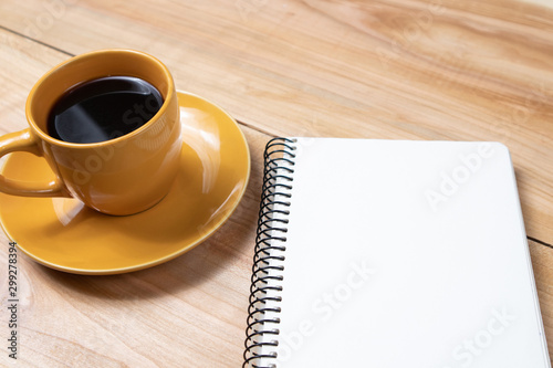 cup of black flavored coffee on wooden background notebook plan day break business meeting negotiation