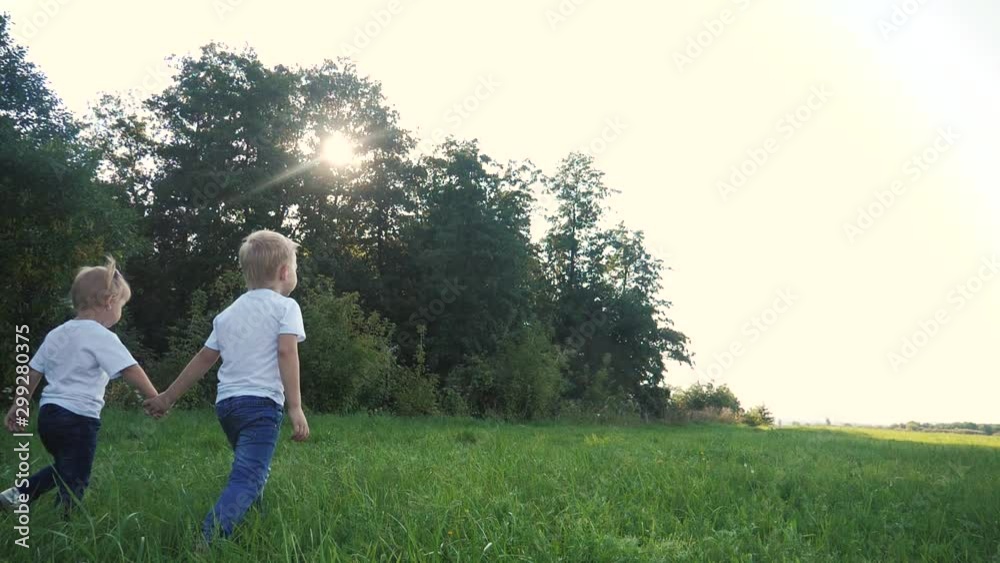 Happy family walking: funny slow motion video little kid boy hold hands go nature play whirl a and girl brother and sister hold hand on nature happy children lifestyle concept. children happy family Happy family walking: funny slow motion video little kid boy hold hands go nature play whirl a and girl brother and sister hold hand on nature happy children lifestyle concept. children happy family