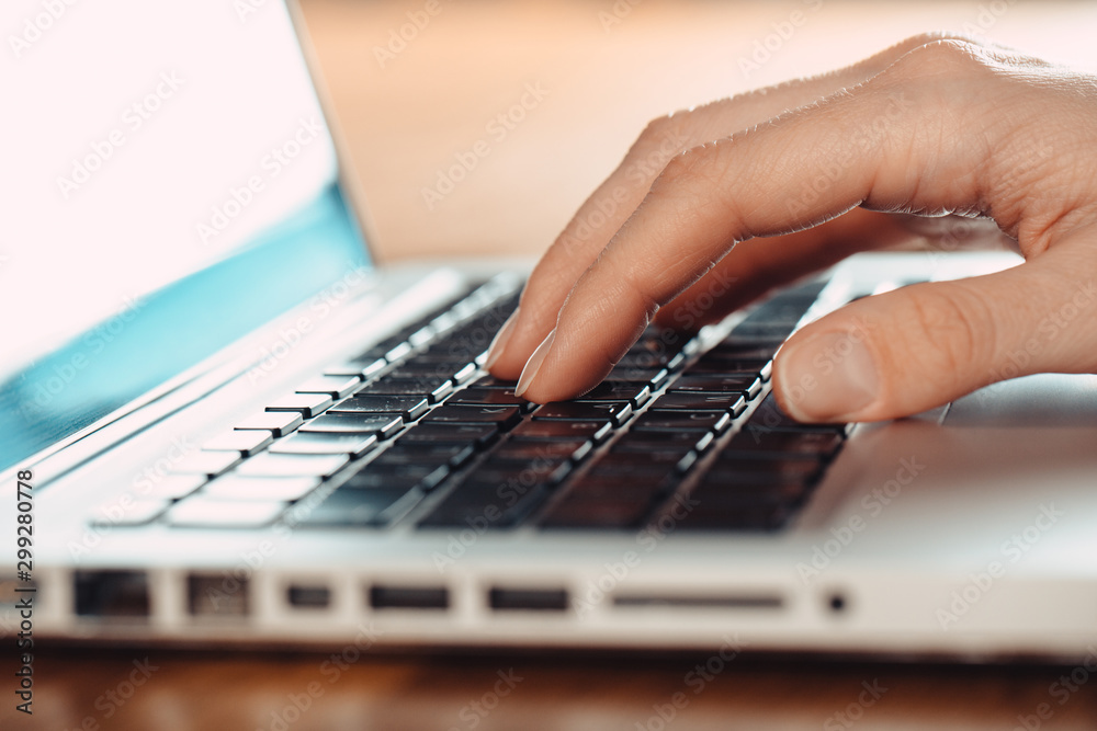 Woman working at home office hand on keyboard close up Woman working at home office hand on keyboard close up