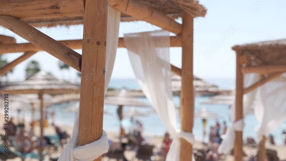 Beach hut shelter on a jam packed beach, closeup depth of field shot