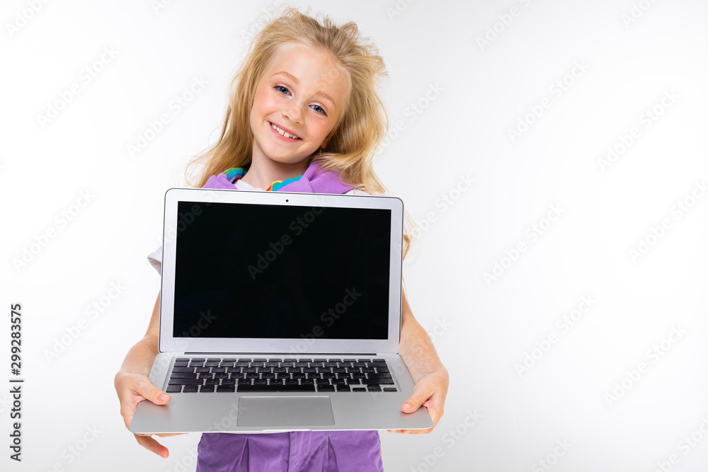 Fototapeta premium portrait of a beautiful schoolgirl with a beautiful haircut on a white isolated background with a laptop screen forward
