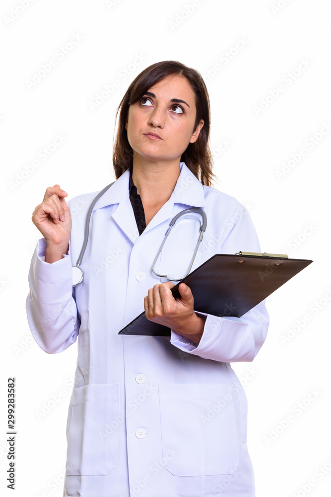 Studio shot of beautiful woman doctor holding clipboard Studio shot of beautiful woman doctor holding clipboard