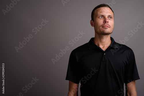 Portrait of handsome man against gray background