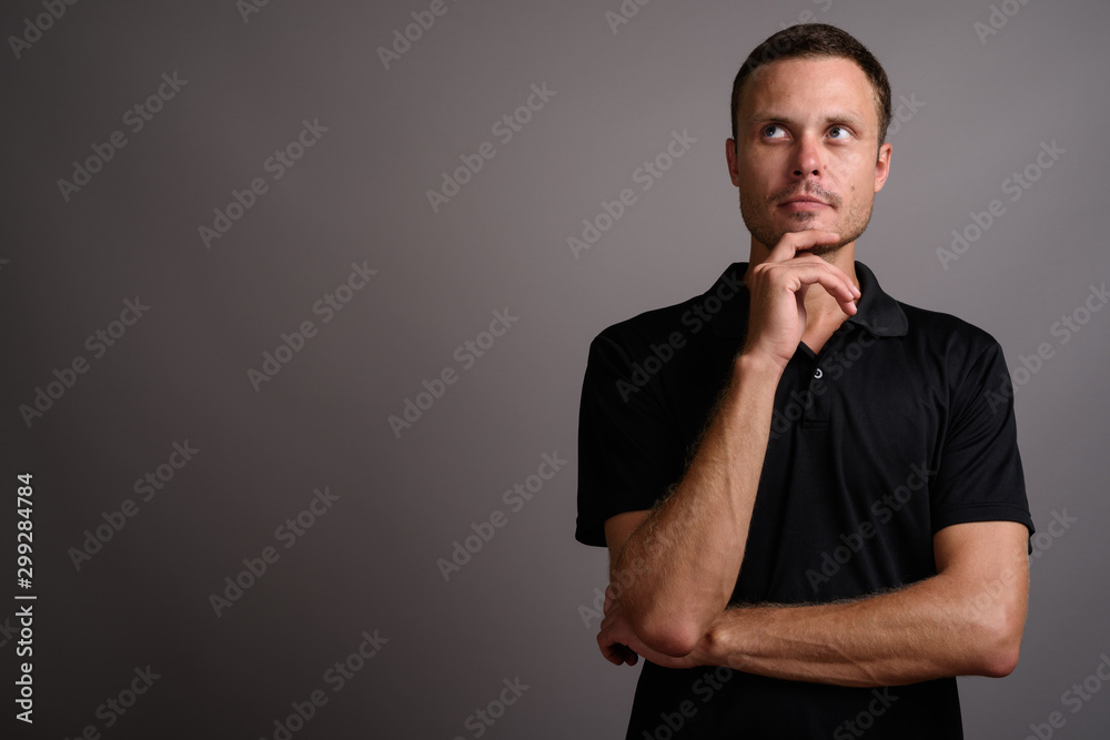 Portrait of handsome man against gray background