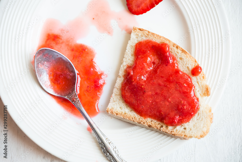 Homemade strawberry jam with fresh fruit on white Homemade strawberry jam with fresh fruit on white