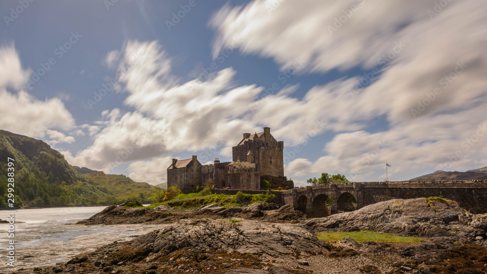 Eilean Donan Castle, Loch Duich, Scotish highlands, with some white clouds on the sky, Scotland, United Kingdom. Long exposure.