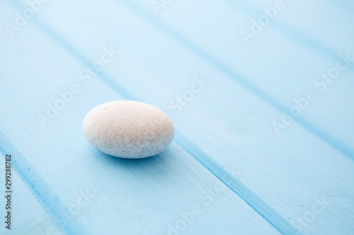 One white stone on a blue table