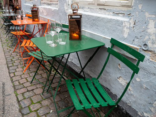 Colorful seating in Copenhagen street cafe with lantern