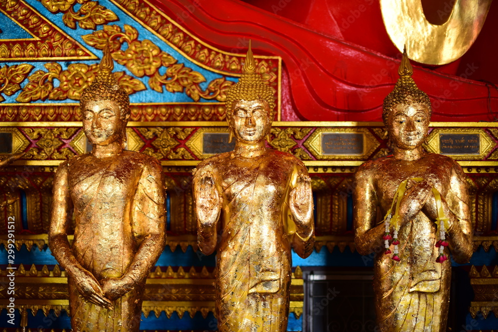 Fototapeta premium The golden Buddha image. Reverence in Buddhist sutras At Wat Luang Pothit, Thailand
