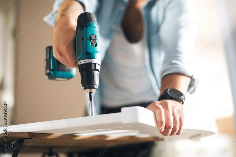 Electric screwdriver in male hands Electric screwdriver in male hands
