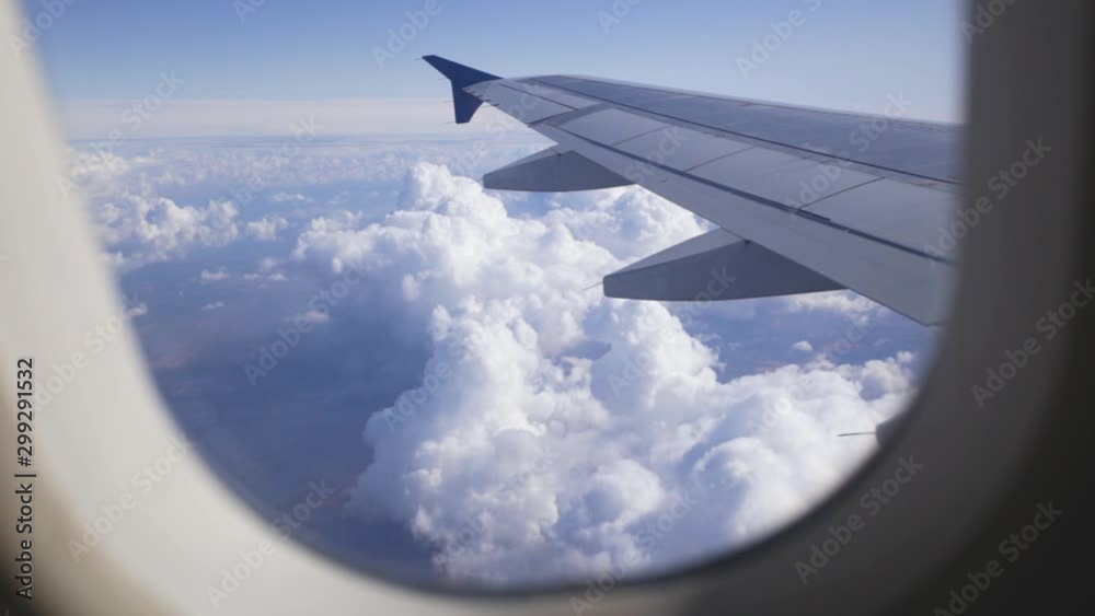 Amazing aerial landscape as seen through porthole of flying airplane. Real time full hd video footage.