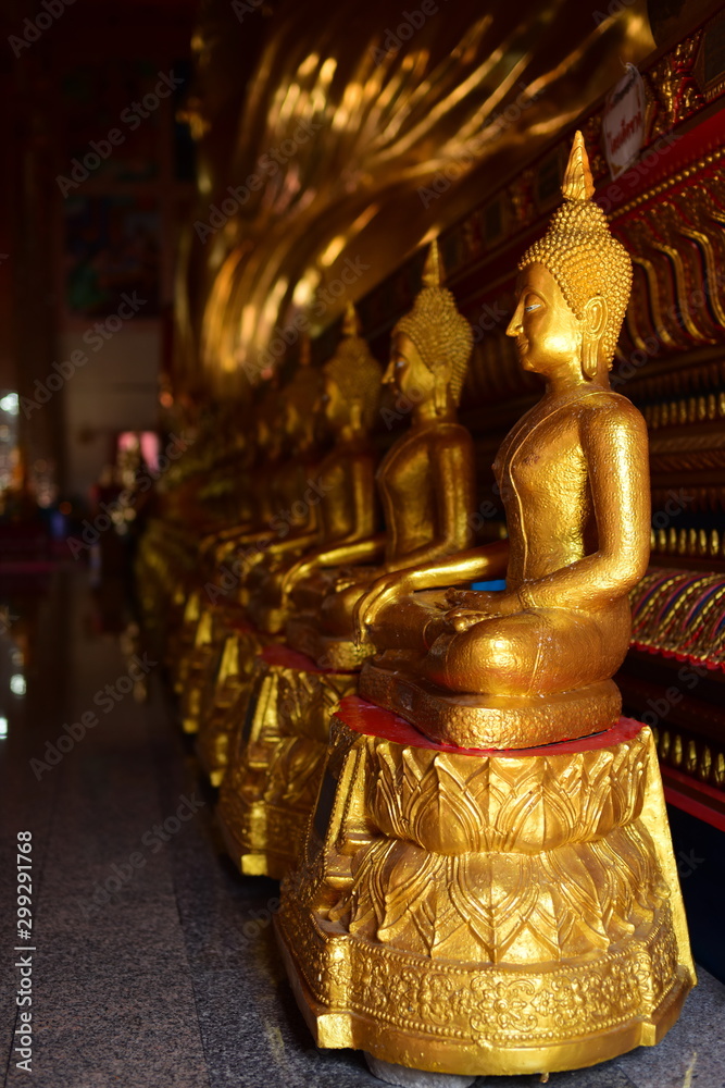 Golden statue of buddha in temple, Thailand
