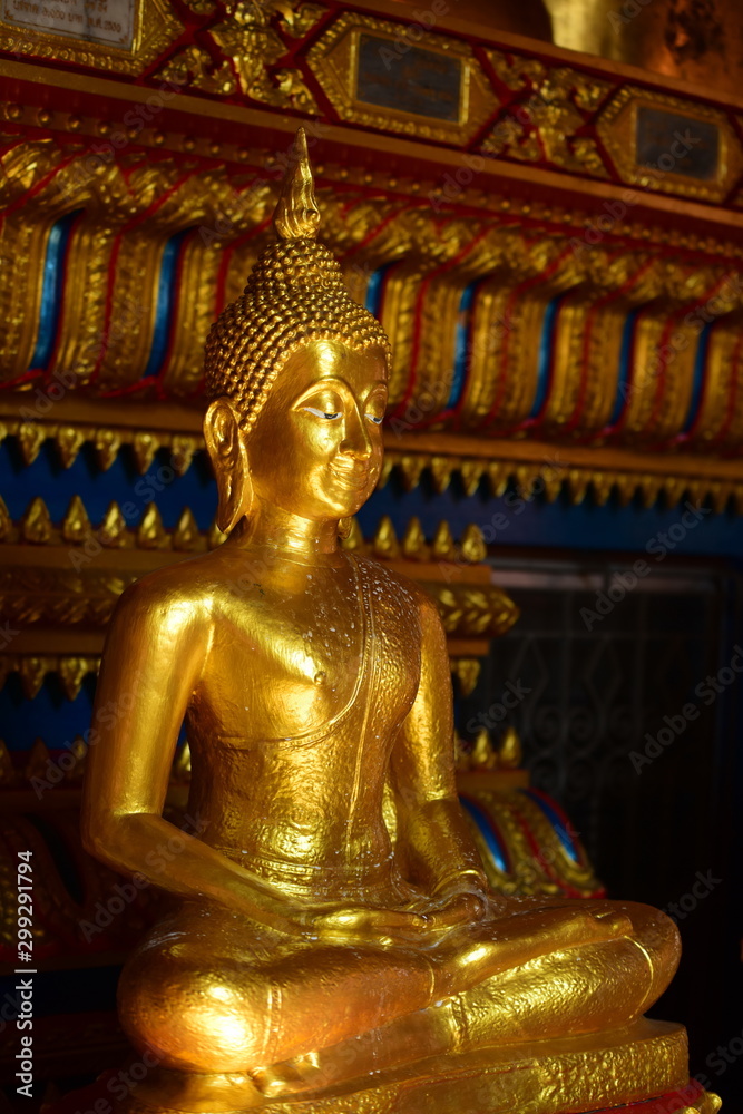 Golden statue of buddha in temple, Thailand