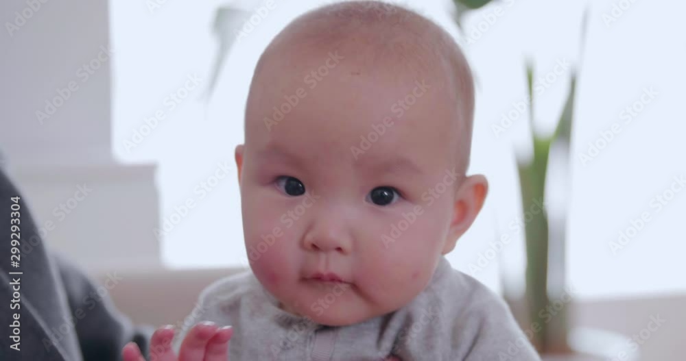 Close up of one lovely baby asian girl looking at camera newborn baby smile portrait of 6 months old infant adorable face baby girl say Hi to the camera Close up of one lovely baby asian girl looking at camera newborn baby smile portrait of 6 months old infant adorable face baby girl say Hi to the camera