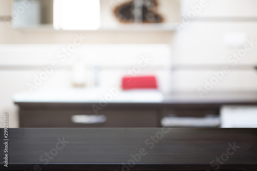 Black empty wooden table and interior kitchen background, product display, blurred light interior background with bokeh kitchen, Ready for product montage