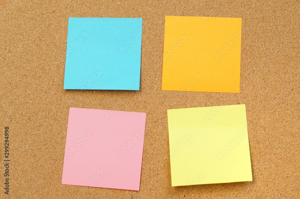 Sticky and pin blank paper notes on cork board to remind.