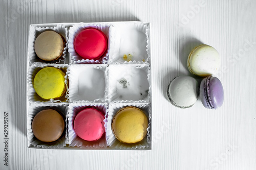 White pack with Macarons cookie, on a white wooden background. View from above. Copy space photo