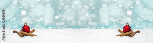 Red baubles and cinnamon sticks on snow snowflakes - Christmas winter background banner long © Corri Seizinger