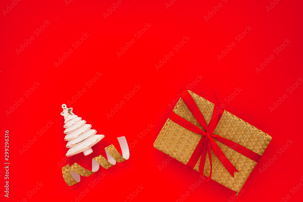 Christmas composition. Beautiful toys, gifts and candy on the red background. New year background. Top view. Close up. Space for a text.