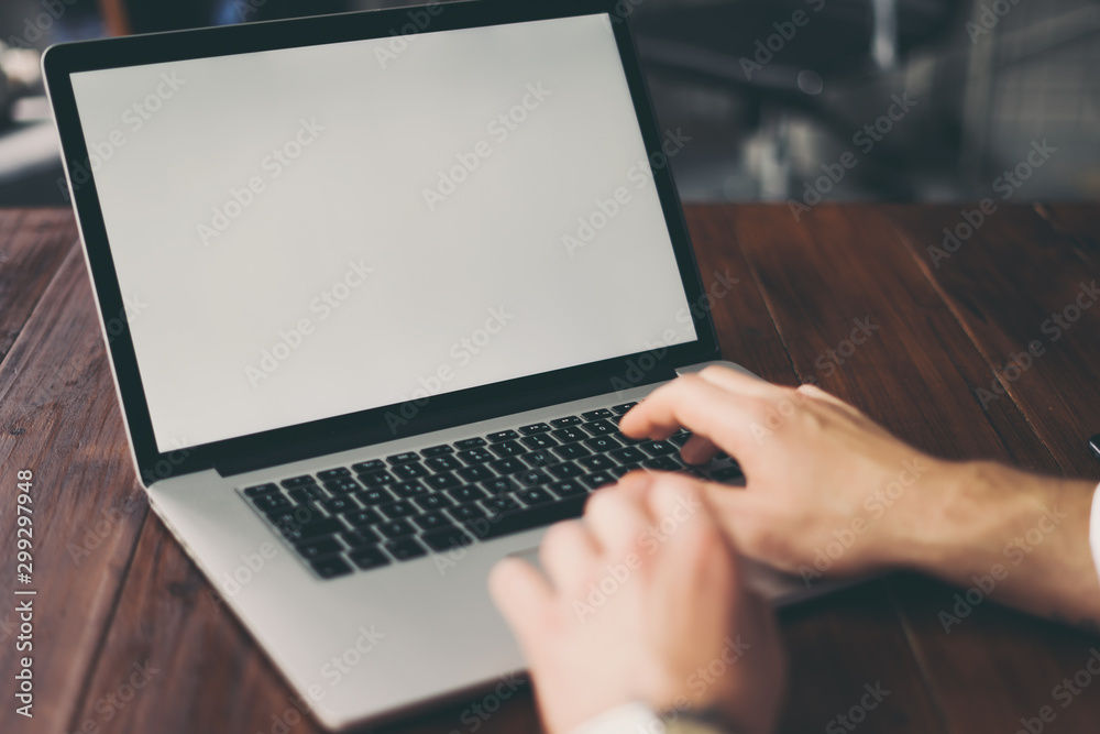 Close up of male hands and laptop with blank screen. Mock-up of computer monitor. Copyspace ready for design or text Close up of male hands and laptop with blank screen. Mock-up of computer monitor. Copyspace ready for design or text