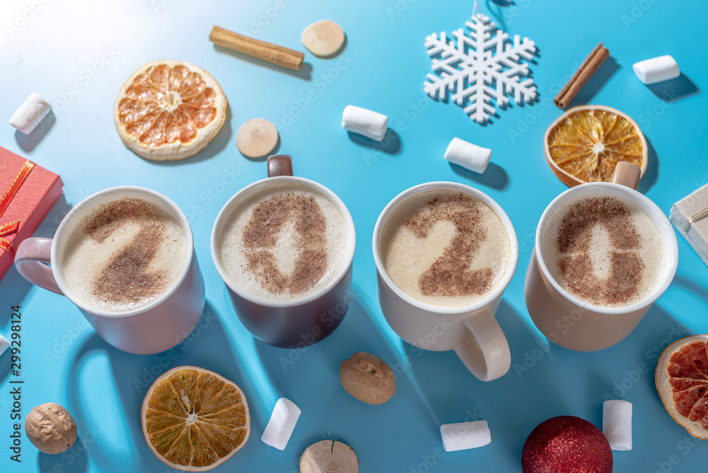 Card with numbers 2020 for New year and Christmas. Cup of coffee with figures on blue background. Top view. Flat lay Card with numbers 2020 for New year and Christmas. Cup of coffee with figures on blue background. Top view. Flat lay