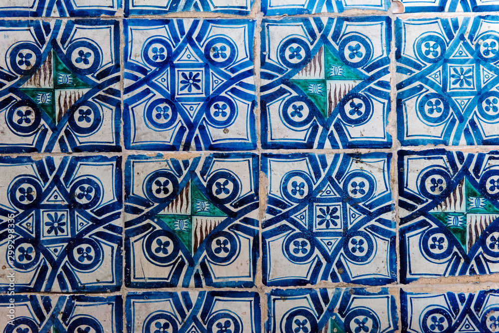 white and blue italian ceramic tile pattern on a floor