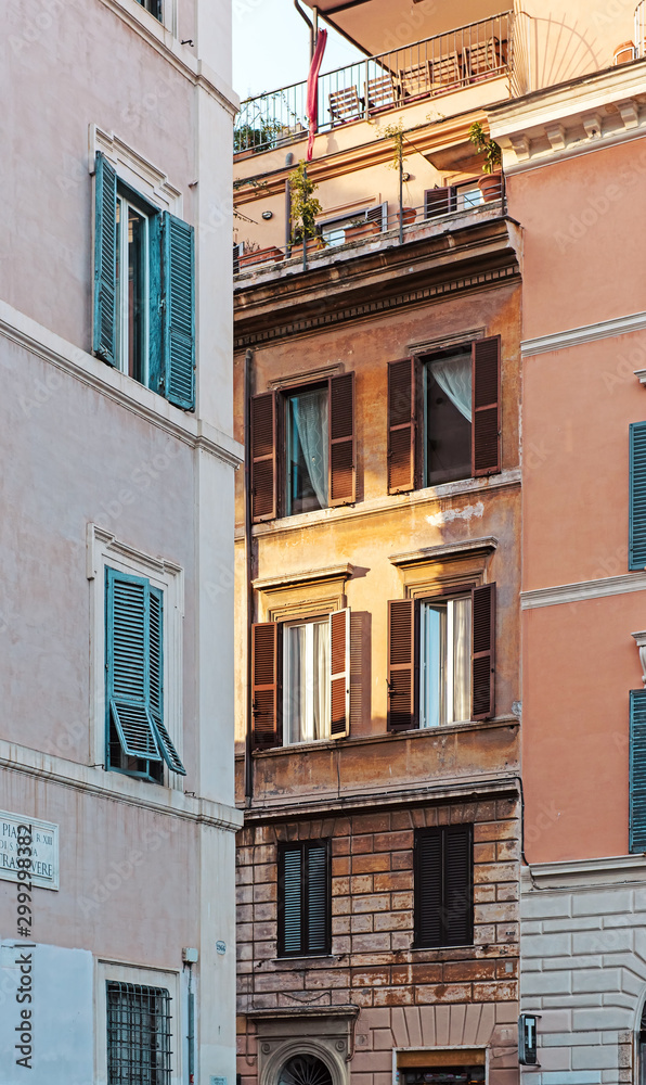 Windows on facade of Rome building. Italy