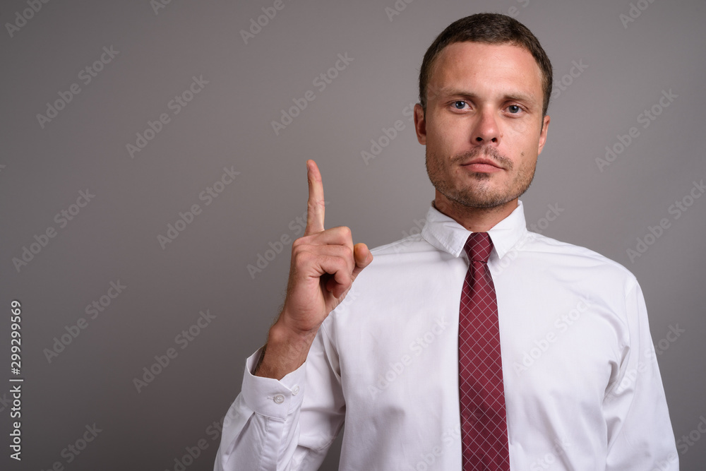 Portrait of handsome businessman against gray background Portrait of handsome businessman against gray background
