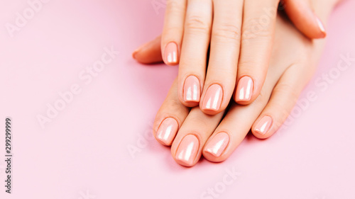Beautiful Woman Hands. Spa and Manicure concept. Female hands with pink manicure. Soft skin  skincare concept. Beauty nails. over beige background.