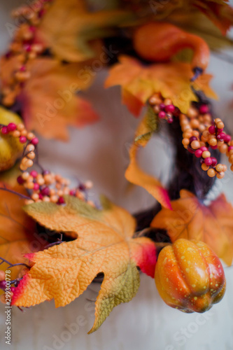 Autumn wreath with leaves, pumpkins and berries photo