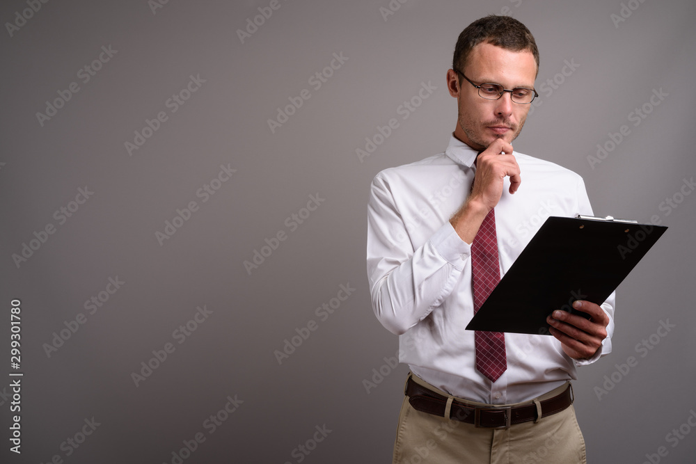 Portrait of handsome businessman against gray background Portrait of handsome businessman against gray background