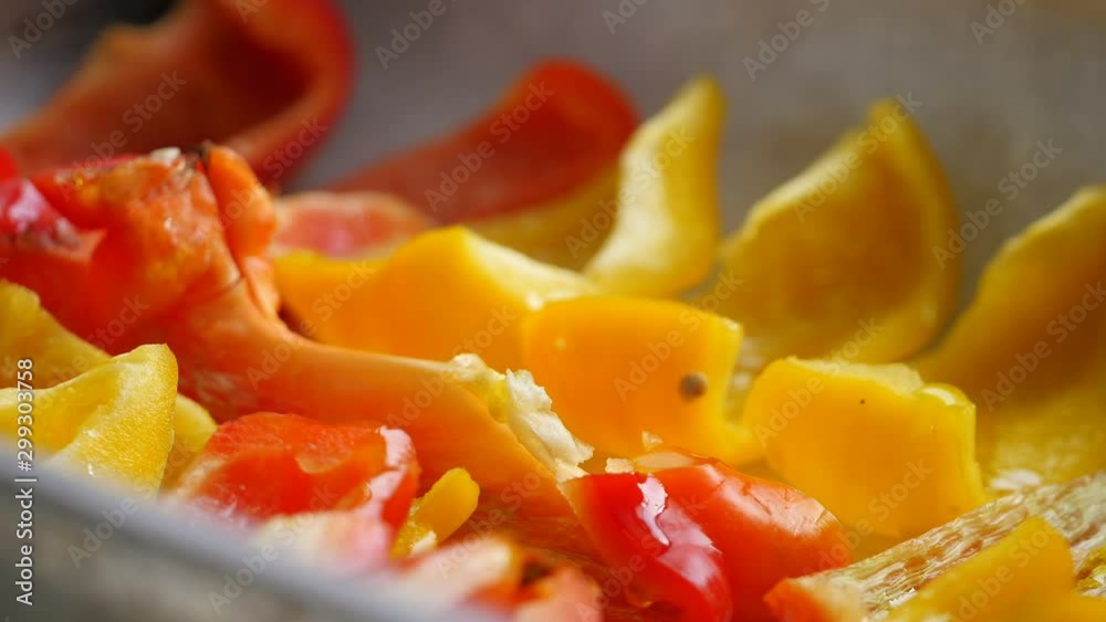 preparation of yellow and red peppers. Pouring olive oil on sliced pepperoni. vegetable cooking, Vegetable ingredients for a healthy dinner or lunch. Seasoning peppers, seasonal cooking. close up preparation of yellow and red peppers. Pouring olive oil on sliced pepperoni. vegetable cooking, Vegetable ingredients for a healthy dinner or lunch. Seasoning peppers, seasonal cooking. close up