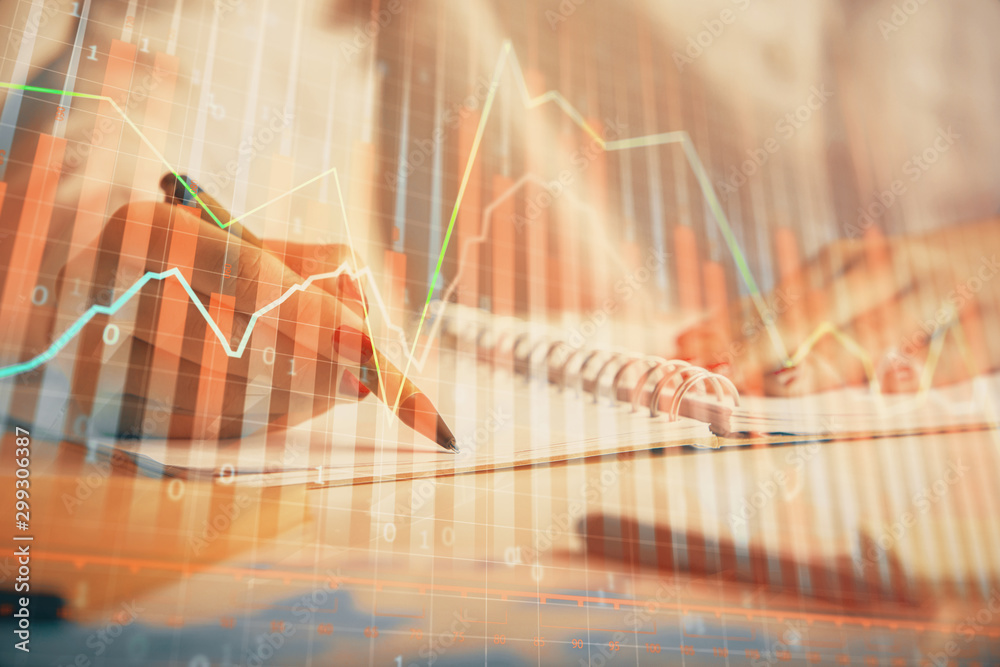 Double exposure of woman's hands making notes with forex graph hologram. Concept technical analysis. Double exposure of woman's hands making notes with forex graph hologram. Concept technical analysis.