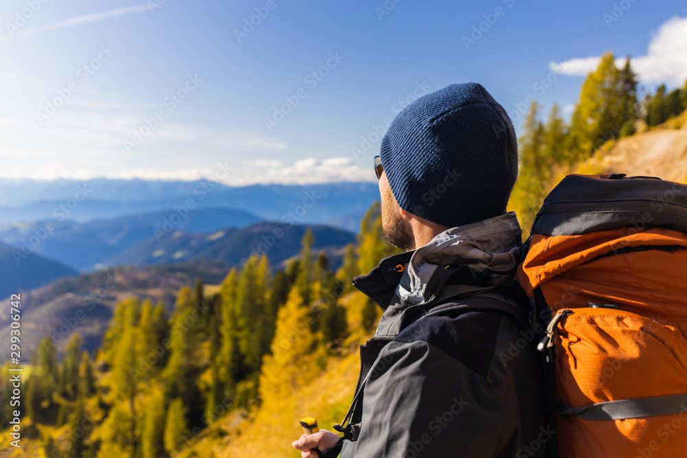 A man stands on a trail and looks at the beautiful Dolomite Alps Valley A man stands on a trail and looks at the beautiful Dolomite Alps Valley
