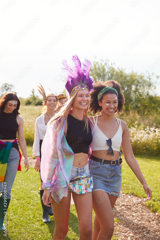 Fototapeta premium Female Friends Walking Back To Tent After Outdoor Music Festival