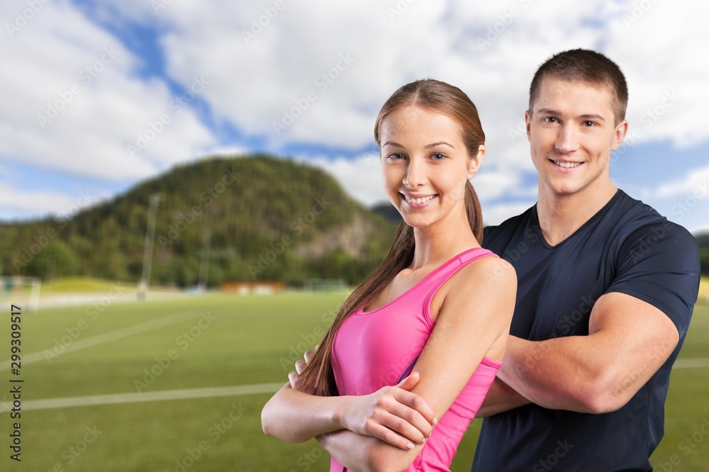 Young sportive couple on white background