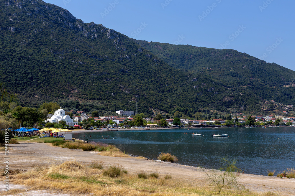 View of the embankment city Kamena Wurla against the background of the sea and mountains (Greece, Phthiotis)