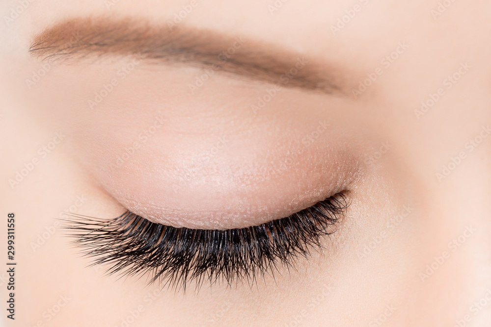 Naklejka premium Macro woman eye with beautiful brown red shades smokey makeup fashion. Concept eyelashes extensions procedure