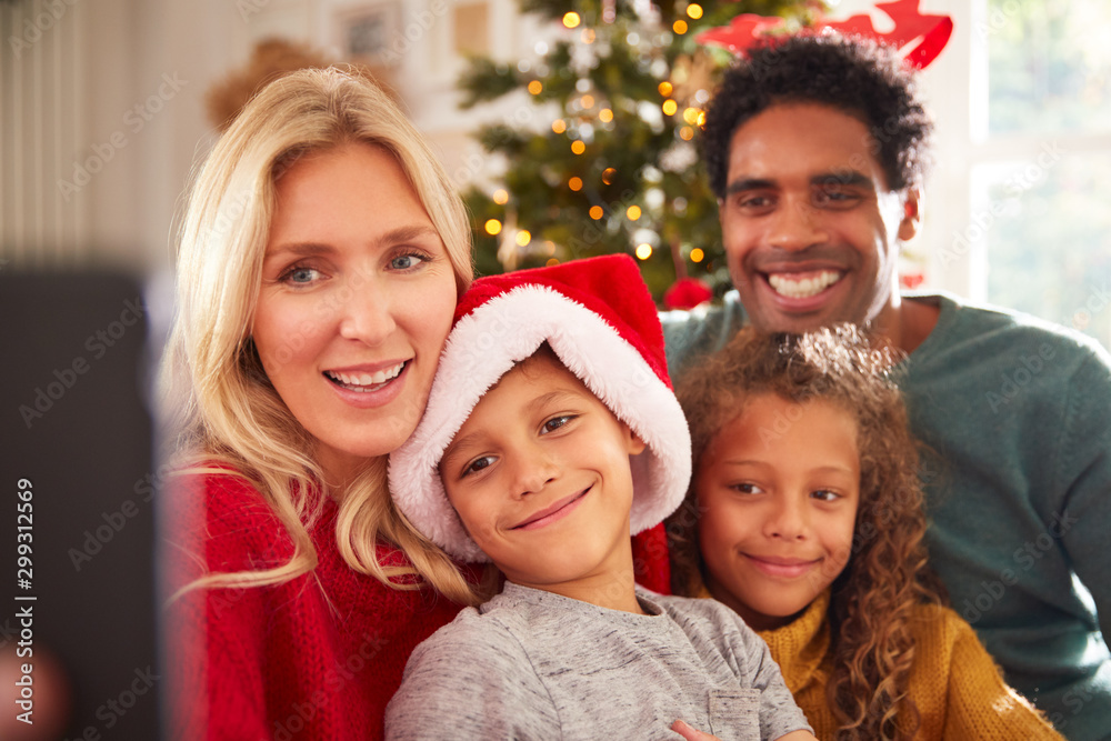 Portrait Of Family Posing For Selfie Sitting On Sofa Celebrating Christmas Together Portrait Of Family Posing For Selfie Sitting On Sofa Celebrating Christmas Together