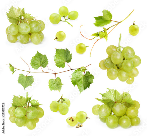 Set of fresh ripe grapes and leaves on white background