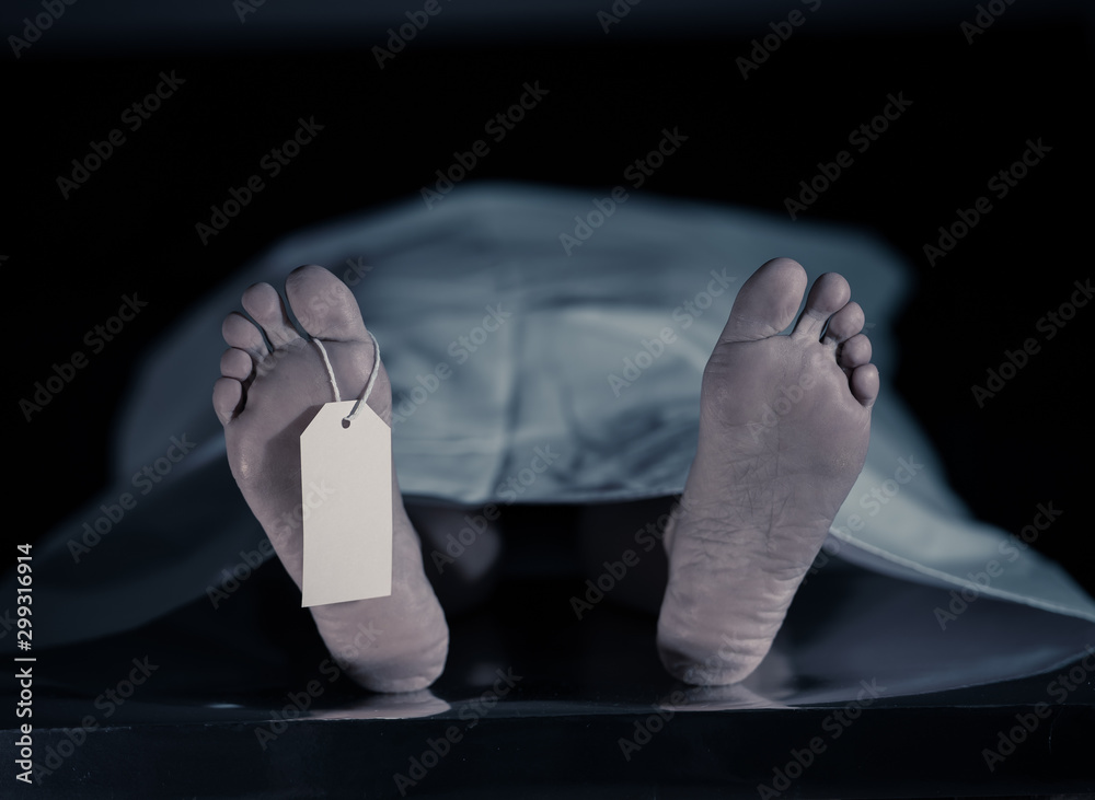 Cadaver on autopsy table at morgue, label tied to toe, close-up Stock ...