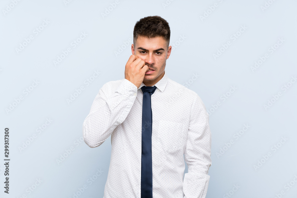 Handsome businessman over isolated blue background nervous and scared Handsome businessman over isolated blue background nervous and scared