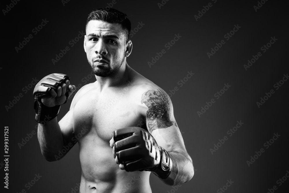 Portrait of young muscular Hispanic man as boxer shirtless