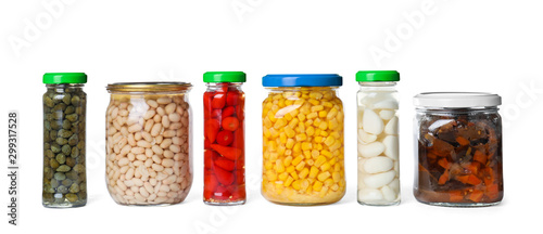 Different jars with pickled vegetables on white background