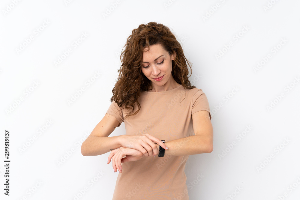 Young pretty woman over isolated background with wrist watch Young pretty woman over isolated background with wrist watch