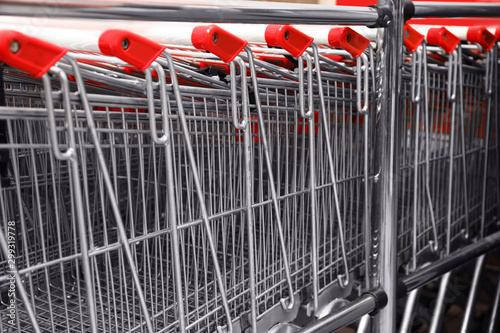 Many empty shopping carts in supermarket, closeup
