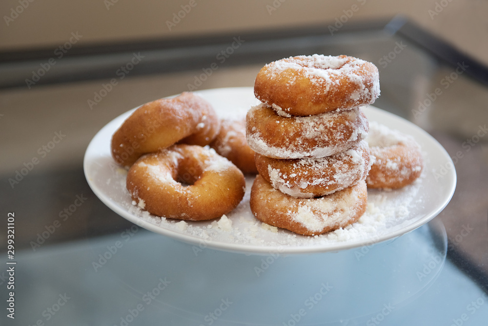 donuts on a plate in powdered sugar