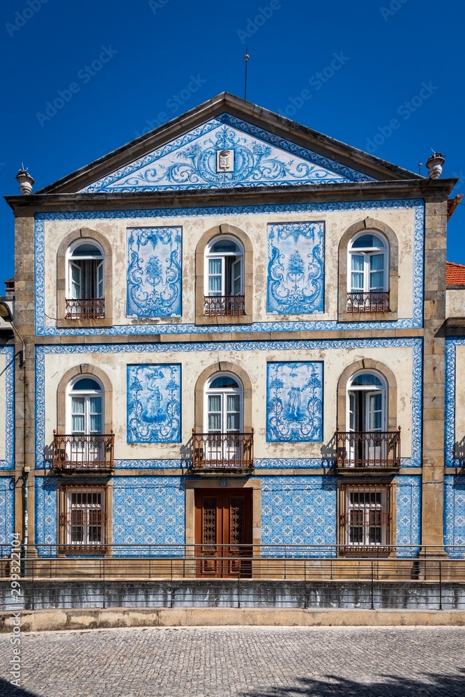 Traditional Portuguese house covered with typical colorful tiles or azulejos.