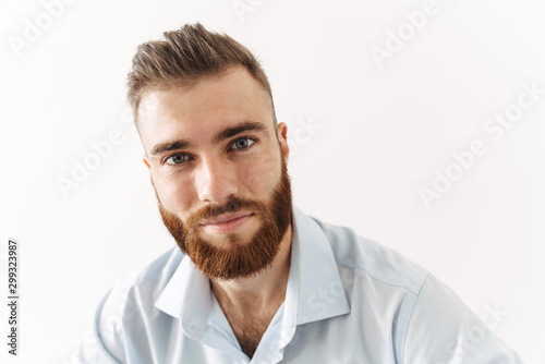 Image of happy handsome bearded man in shirt looking at camera