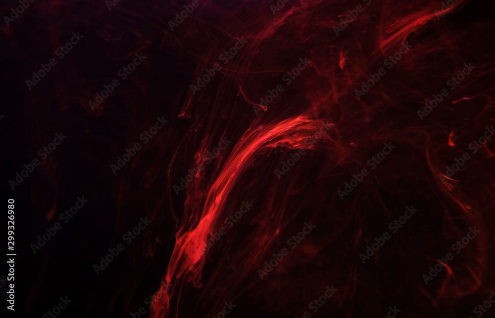 Fototapeta premium drops of paint in the water randomly flowing in different colors.